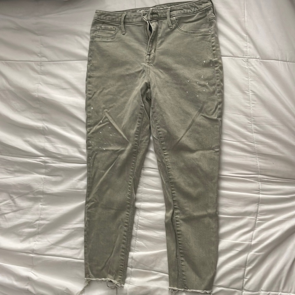 Mossimo sage green jeans size 10 with frayed ends and bleach splatter details